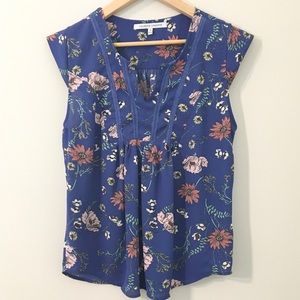 Cap-sleeved floral print blouse.